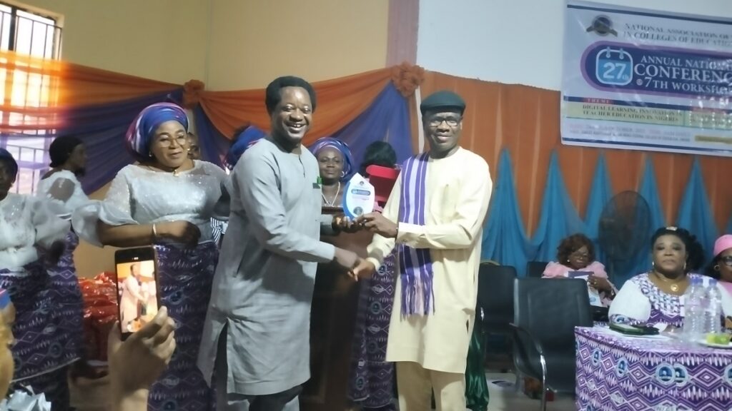 Executive Secretary, NCCE, Prof Okwelle presenting an award of excellence to the Provost, Ebonyi State College of Education, Dr Mba